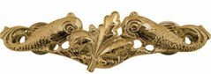 A gold embroidered or gold metal pin with two dolphins facing a supply corps oak leaf in the center.