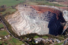 A large pit in the ground where stone, sand, etc. is dug for use as building material: