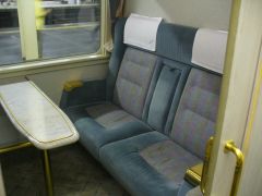 one of the separate areas inside a vehicle, especially a train:a first-class compartment