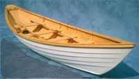 a small flat-bottomed rowboat with a high bow & stern, of a kind originally used for fishing in New England