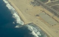 The figure below shows manmade objects that extend from the beach and help to minimize erosion that reduce the size of the beaches. What are these manmade objects called?