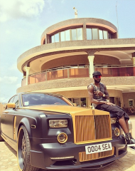 EA Emmanuel Adebayor sitting on a Rolls Royce