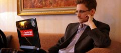 ES Edward Snowden looking at a laptop