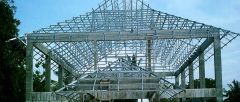 Structural support made from a long steel bar that is bent at a 90-degree angle with flat or angular pieces welded to the top and bottom.
