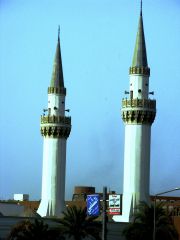 Tower attached to a Muslim mosque, having one or more projecting balconies from which a crier calls Muslims to prayer.