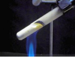 -solid sublimes in upper part of test tube
