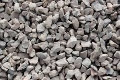 A coarse granular aggregate, larger than sand, formed either by the flow of water in streams or man-made by crushing larger stones. Used to provide drainage (behind retaining walls), prevent capillary movement of water (beneath footings or pavemen...