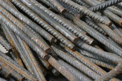 Steel bar having ribs to provide greater bonding strength when used as reinforcing in concrete.