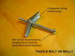 A bolt having a nut with pivoted, flanged wing that dose against a spring when it is pushed through a hole, and open after emerging from the hole; used to fasten objects to a hollow wall or to a wall that is accessible only from one side.