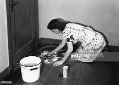 Be (down) ..... => Be down on one's hands and knees


e.g. When the children came home, their mother was down ..... washing the kitchen floor.