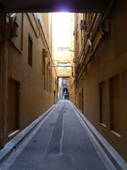 A NARROW STREET OR PASSAGEWAY, USUALLY BEHIND A ROW OF HOUSE OR BUILDINGS


 