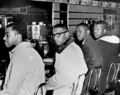 Sit-ins were a new type of protest: black people sat in places like snack bars reserved for whites. The first occurred in Greensboro, North Carolina. Many sit-ins were organised by students who met violent aggression. The SNCC (Student Nonviolent ...