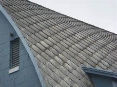 A “fireproof” roofing shingle that is composed of cement reinforced with asbestos fibers.