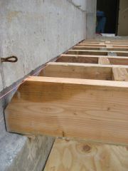 The end of a joist cut at an angle to permit the joist to fall out of a wall without acting like a lever and cushing the wall above it out of place.