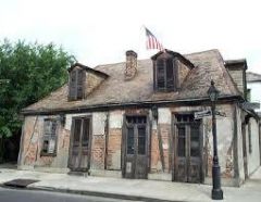 Lafitte's
 Blacksmith Shop.  When this place was built is unknown.  The oldest 
record of ownership dates to1772.  Legend has it that this was a smithy 
operated by the dashing brothers Lafitte, the "hero" pirates of New 
Orleans.