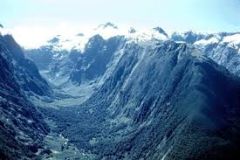Steep sided valleys with flat bottoms, glaciers erode the V shaped to valley to make it wider and deeper - U shaped