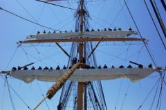 Above the ship's uppermost solid structure, overhead or high above