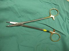 The surgeon uses this instrument to place and cut his sutures. Identify this instrument (see image).