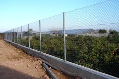 fence (made of wire)("El campo está cerrado por un _______.")