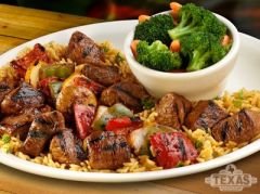 *8 oz. of meat
Marinated cubes of sirloin, red and green peppers, onions, tomato and a mushroom cap served over a bed of rice.
**(Served with one additional side)
Garnish:
*Brushed with melted butter