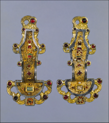 #53


Merovingian looped fibula


Early Medieval Europe


Mid-sixth Century C.E.


_____________________


Content: These are two matching pieces that were created as a pair. They are mostly hammered gold, with designs and inlayed semi-precious st...
