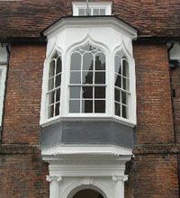 Smaller bay window on an upper story, and is supported by decorative brackets