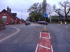 What do the red hatched markings in the middle of the road mean?
