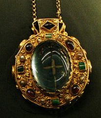 a stone, ring, or other object, engraved with figures or characters supposed to possess occult powers and worn as an amulet or charm

amulet/ disgrace