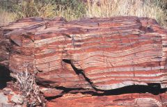 bands of red rock from about 3.8 billion years ago, red due to iron precipitating out of water due to oxygen (and oxygen = living creatures to produce it)