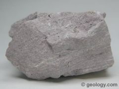 light-colored, fine-grained, extrusive rock that typically contains quartz and feldspar minerals.