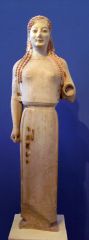 An Archaic statue of a young woman. Greek and Aegean.
