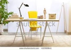 the yellow chair is behind the table
