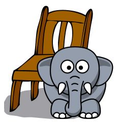There is an elephant in front of the chair.