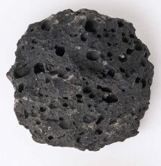Bubbles which result in holes in the completely solidified rock.
