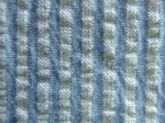Made by slack-tension weaving process which puckers the fabric.

Has vertical crinkled stripes