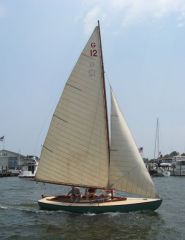 a one-masted sailboat with a fore-and-aft mainsail and a jib / the most common sailboat