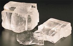 The rock Halite has what type of break and how many directions?