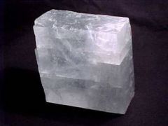 The rock Calcite has what type of break and how many directions?