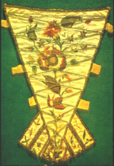A Decorative piece of cloth used to cover the corset where it was exposed by the front of the dress