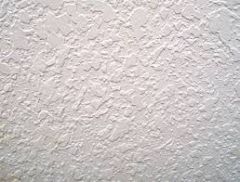 A type of finish texture created with sprayed on texturing material
that is spread flat with a trowel before drying.