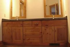 A cabinet that encloses a basin and its water lines and drain, usually furnished with shelves and drawers underneath for storage of toiletries.
