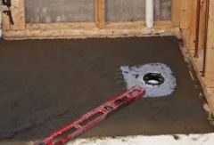 A mortar bed, sloped to the weep holes in the sub‐drain.