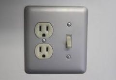 A plate, usually of metal, ceramic, or plastic, covering a switch so that the knob or toggle protrudes.
