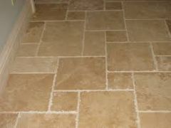 A thin, flat or convex slab of hard material such as baked clay or plastic, laid in rows to cover floors.
