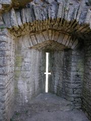 They were narrow openings in the castle's towers through which archers fired their arrows on the enemy below.