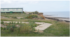 Outline the evidence from Figure 21 that suggests erosion is taking place on this coast (3)