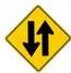 This warning sign means?
A) Two-way traffic ahead.
B) Divided highway ends.
C) Divided highway begins.
D) One-way traffic ahead.