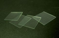 a thin flat piece of transparent material, usually square or rectangular, that is placed over objects for viewing with a microscope.