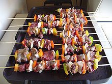 (America) brochette or skewers, also, the meat and vegetables placed on them for cooking